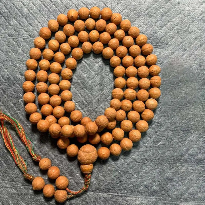 A BWOOOH 108-bead Nepal Bodhi Seed Mala bracelet, handcrafted with unique dark-speckled seeds on premium string, for meditation, enlightenment, and positive energy. - View 11