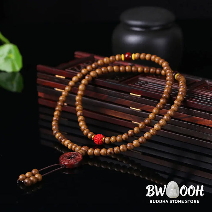 BWOOOH 108 Mala Beads handcrafted from natural Peach Wood and Bodhi Seeds, featuring a detailed Lotus charm, designed for mindful prayer and meditation. - View 6