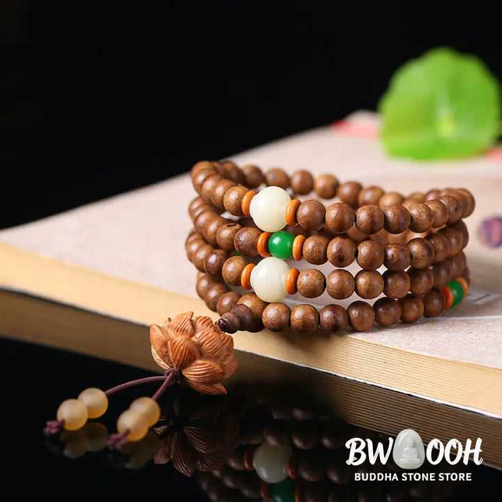 BWOOOH 108 Mala Beads handcrafted from natural Peach Wood and Bodhi Seeds, featuring a detailed Lotus charm, designed for mindful prayer and meditation. - View 2