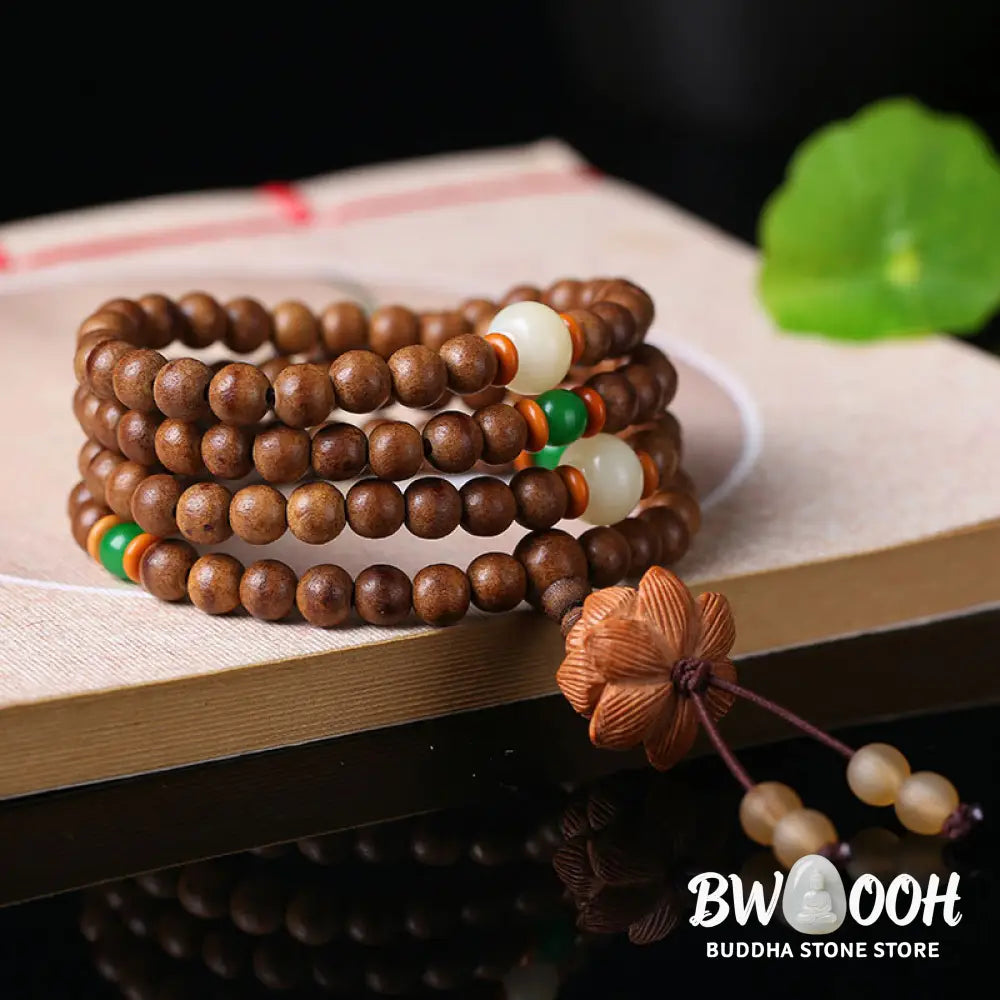 BWOOOH 108 Mala Beads handcrafted from natural Peach Wood and Bodhi Seeds, featuring a detailed Lotus charm, designed for mindful prayer and meditation. - View 3