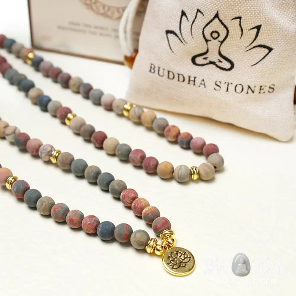 BWOOOH 108 Mala beads bracelet featuring naturally textured 8mm Picasso Jasper stones, accented with a delicate Lotus Symbol charm, symbolizing courage and spiritual resilience on an elastic band. - View 6