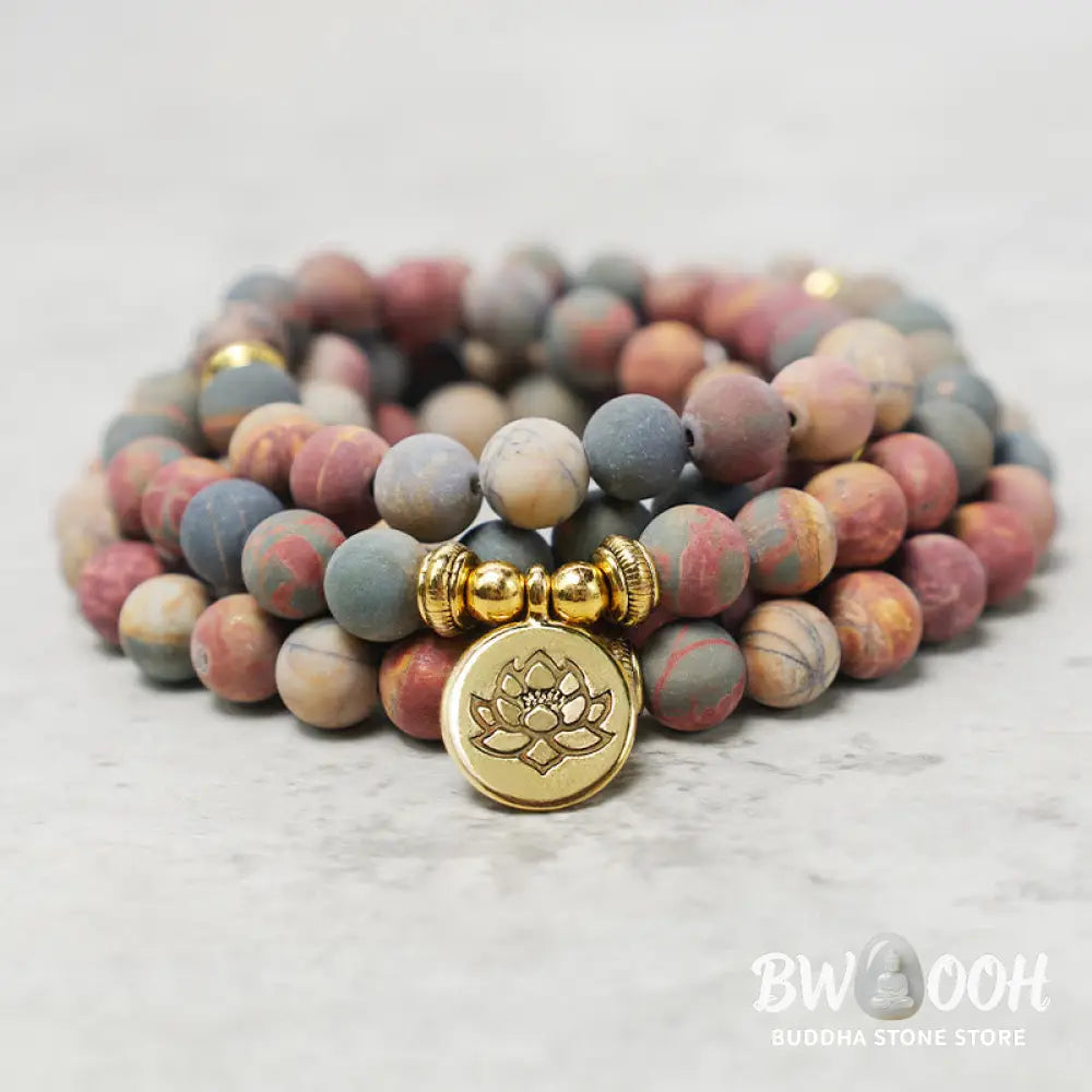 BWOOOH 108 Mala beads bracelet featuring naturally textured 8mm Picasso Jasper stones, accented with a delicate Lotus Symbol charm, symbolizing courage and spiritual resilience on an elastic band. - View 2