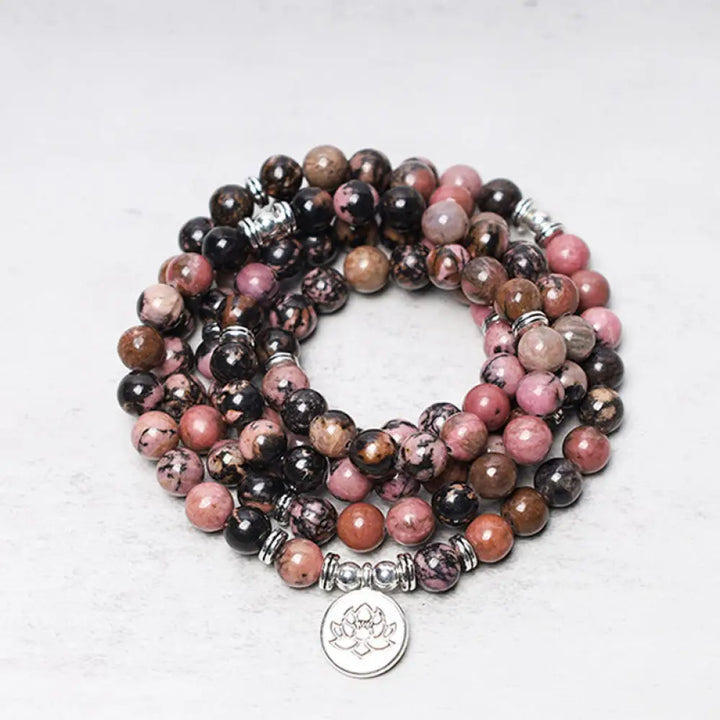 BWOOOH 108 Rhodonite Mala Beads with an intricate Lotus symbol charm, showcasing the deep pink hues of the 8mm compassion energy stones and premium elastic band for a 15-19cm wrist.