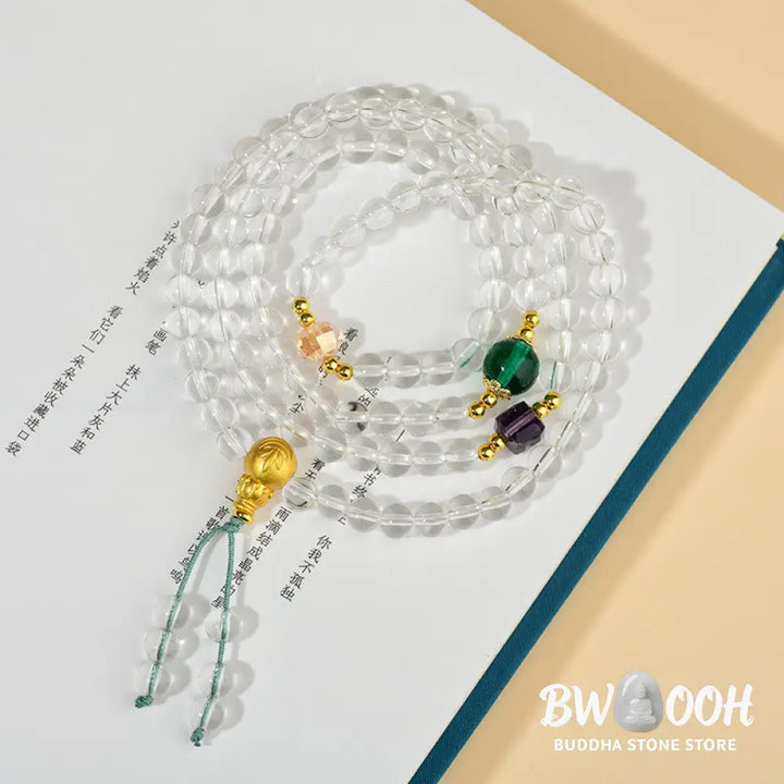 A close-up of the BWOOOH 108 Mala Beads White Crystal Clarity Bracelet, handcrafted with polished clear white crystal beads (7*9mm) on a premium elastic string, suitable for meditation and spiritual focus. The mala includes subtle alloy and Liuli accents, resting gently on a textured, serene background, highlighting its calming essence. - View 4