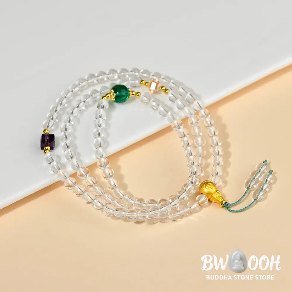 A close-up of the BWOOOH 108 Mala Beads White Crystal Clarity Bracelet, handcrafted with polished clear white crystal beads (7*9mm) on a premium elastic string, suitable for meditation and spiritual focus. The mala includes subtle alloy and Liuli accents, resting gently on a textured, serene background, highlighting its calming essence. - View 3