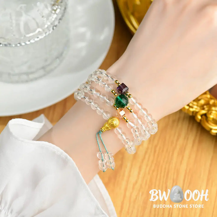 A close-up of the BWOOOH 108 Mala Beads White Crystal Clarity Bracelet, handcrafted with polished clear white crystal beads (7*9mm) on a premium elastic string, suitable for meditation and spiritual focus. The mala includes subtle alloy and Liuli accents, resting gently on a textured, serene background, highlighting its calming essence. - View 7