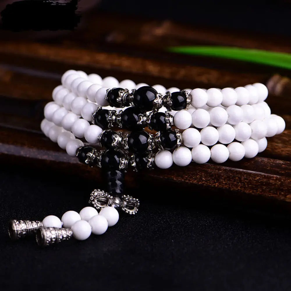 BWOOOH 108 White Porcelain Mala Beads Patience Bracelet. Features 'Om Mani Padme Hum' mantra, symbolizing purity and focus for meditation.