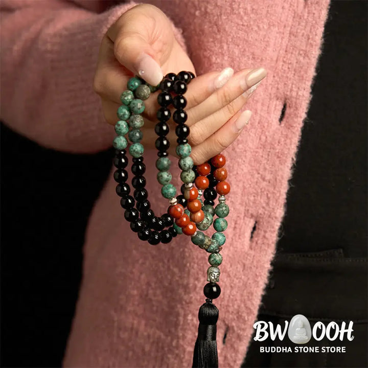 BWOOOH 108 Mala Protection Bracelet featuring 8mm natural Black Onyx, Red Jasper, and Turquoise beads, with a detailed Buddha Head charm and traditional tassel, displayed as a meditation accessory for spiritual balance and personal empowerment. - View 5