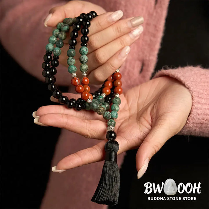BWOOOH 108 Mala Protection Bracelet featuring 8mm natural Black Onyx, Red Jasper, and Turquoise beads, with a detailed Buddha Head charm and traditional tassel, displayed as a meditation accessory for spiritual balance and personal empowerment. - View 3