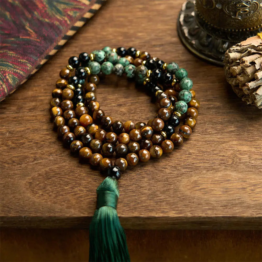 BWOOOH 108 Mala meditation bracelet featuring polished 8mm Tiger Eye and Turquoise beads, with a traditional tassel, symbolizing protection, courage, and balance for spiritual growth and mindful practice.