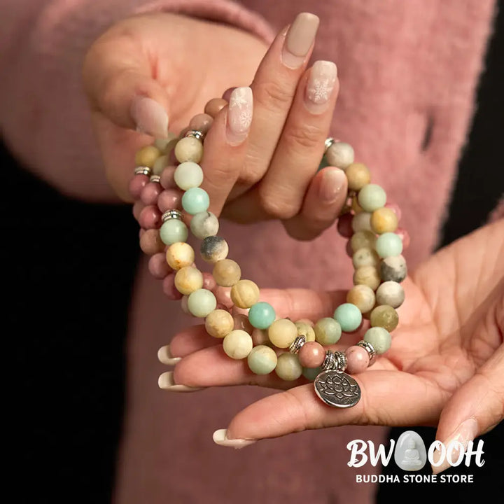 BWOOOH 108 Mala bracelet featuring polished 8mm Rhodonite and Amazonite beads, adorned with a round, intricately engraved Lotus charm, symbolizing compassion and inner harmony. - View 3
