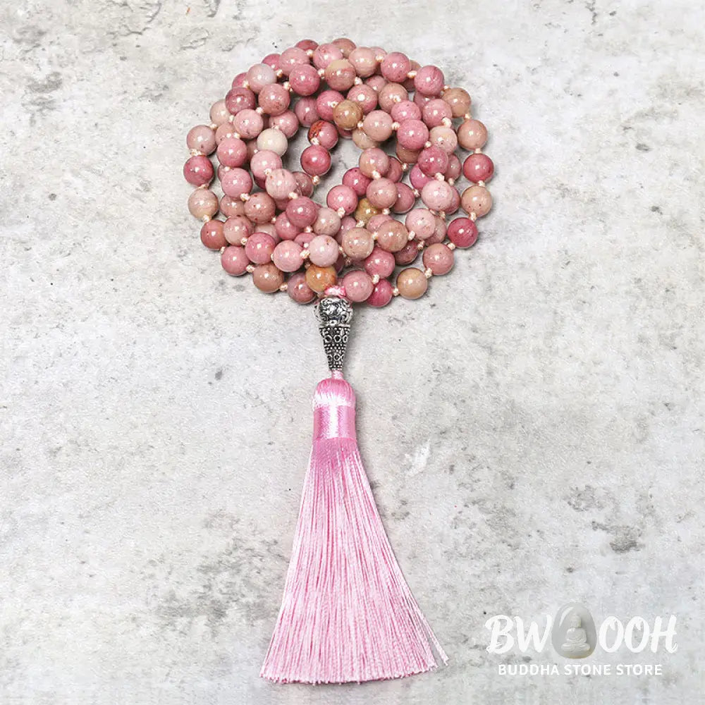 BWOOOH 108-bead Rhodonite Mala, a meditation bracelet or necklace featuring 8MM polished, natural pink rhodonite beads known for loving energy and healing properties, displayed on a tranquil surface. - View 4