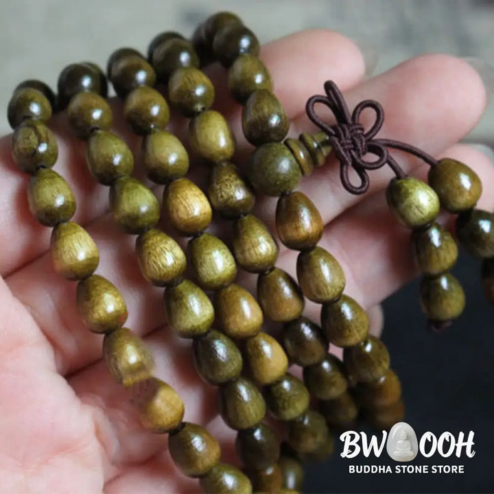 A BWOOOH 108 Mala Teardrop Beads Protection Bracelet, crafted from natural Phoebe Zhennan Wood, showcasing its unique grain and spiritual essence on a clean, mindful background. The premium elastic string is visible. - View 3