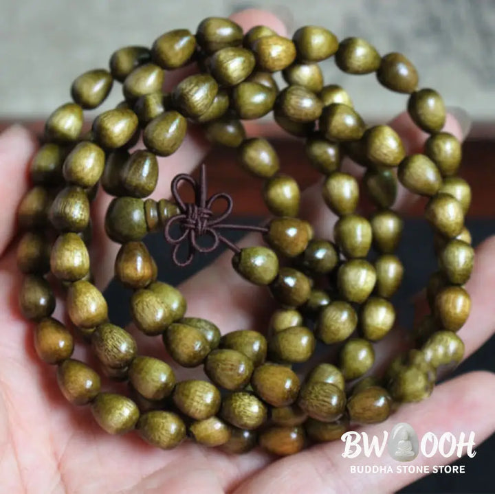 A BWOOOH 108 Mala Teardrop Beads Protection Bracelet, crafted from natural Phoebe Zhennan Wood, showcasing its unique grain and spiritual essence on a clean, mindful background. The premium elastic string is visible. - View 4