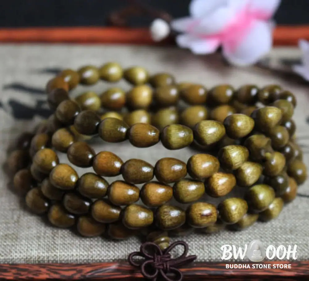 A BWOOOH 108 Mala Teardrop Beads Protection Bracelet, crafted from natural Phoebe Zhennan Wood, showcasing its unique grain and spiritual essence on a clean, mindful background. The premium elastic string is visible. - View 2