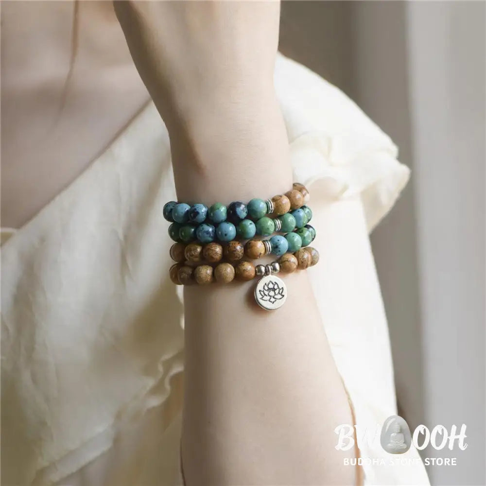 BWOOOH 108-bead meditation mala crafted from natural bodhi seed and speckled picture jasper, featuring a delicate lotus symbol pendant, worn as a multilayer bracelet or necklace. - View 4