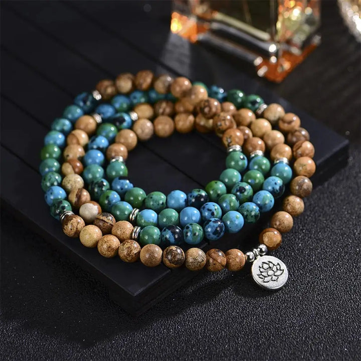 BWOOOH 108-bead meditation mala crafted from natural bodhi seed and speckled picture jasper, featuring a delicate lotus symbol pendant, worn as a multilayer bracelet or necklace.