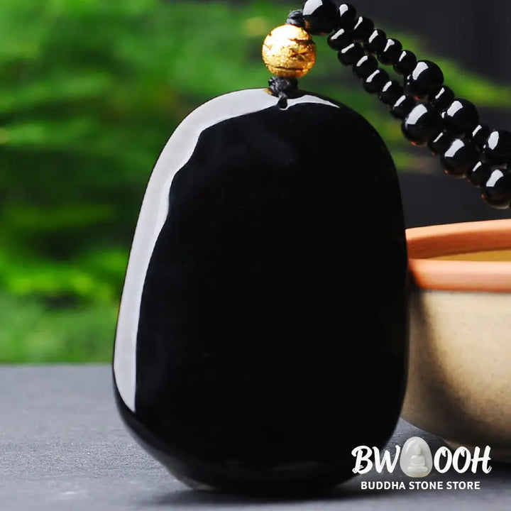 BWOOOH 18k gold-plated dragon obsidian pendant necklace, featuring a carved black obsidian dragon on a golden-hued base, showcasing its protective energy and luxurious finish. - View 5