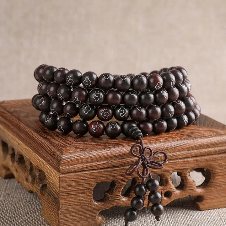 BWOOOH 925 Sterling Silver Inlaid Small Leaf Red Sandalwood Om Mani Padme Hum Auspicious Clouds Protection Bracelet. Features intricate silver inlay on rich red sandalwood beads, ideal for spiritual protection and mindful presence.