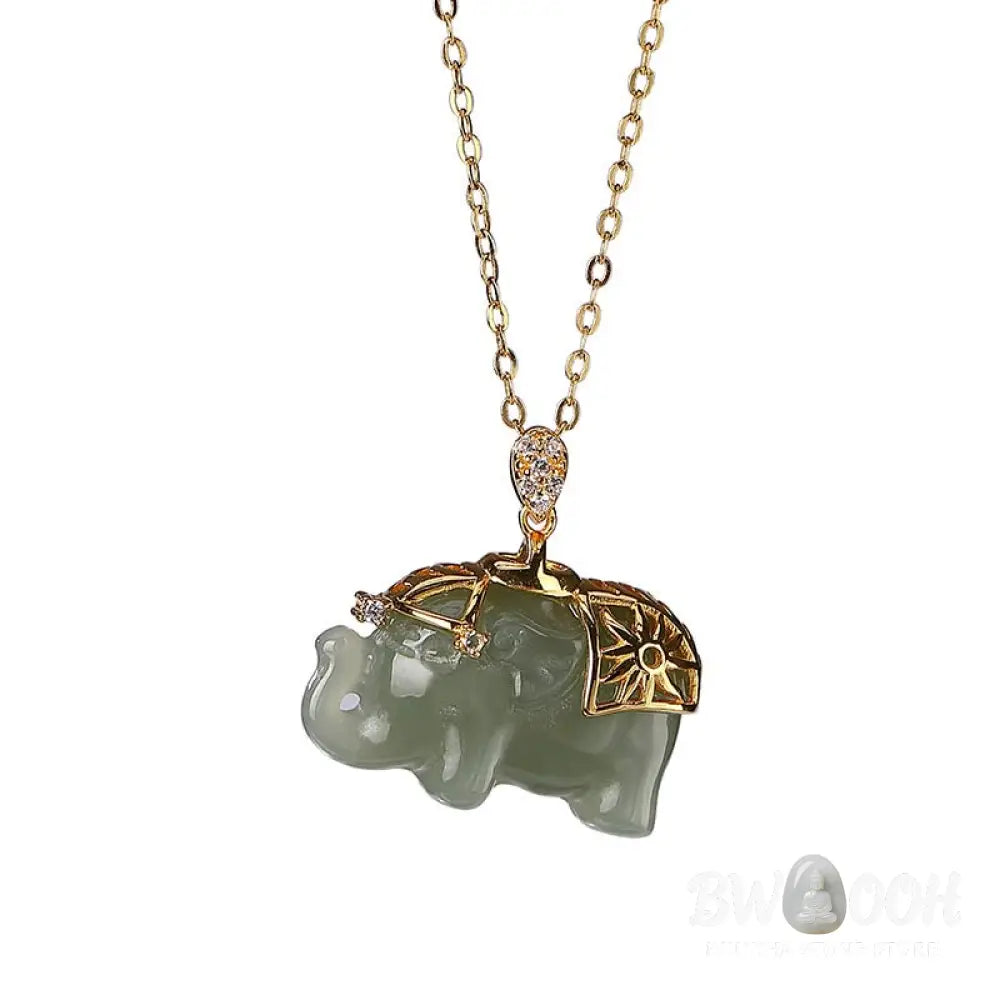 A close-up of the BWOOOH 925 Sterling Silver gold-plated elephant pendant, intricately carved and holding a vibrant jade stone, against a minimalist backdrop, highlighting its 45cm chain. - View 9