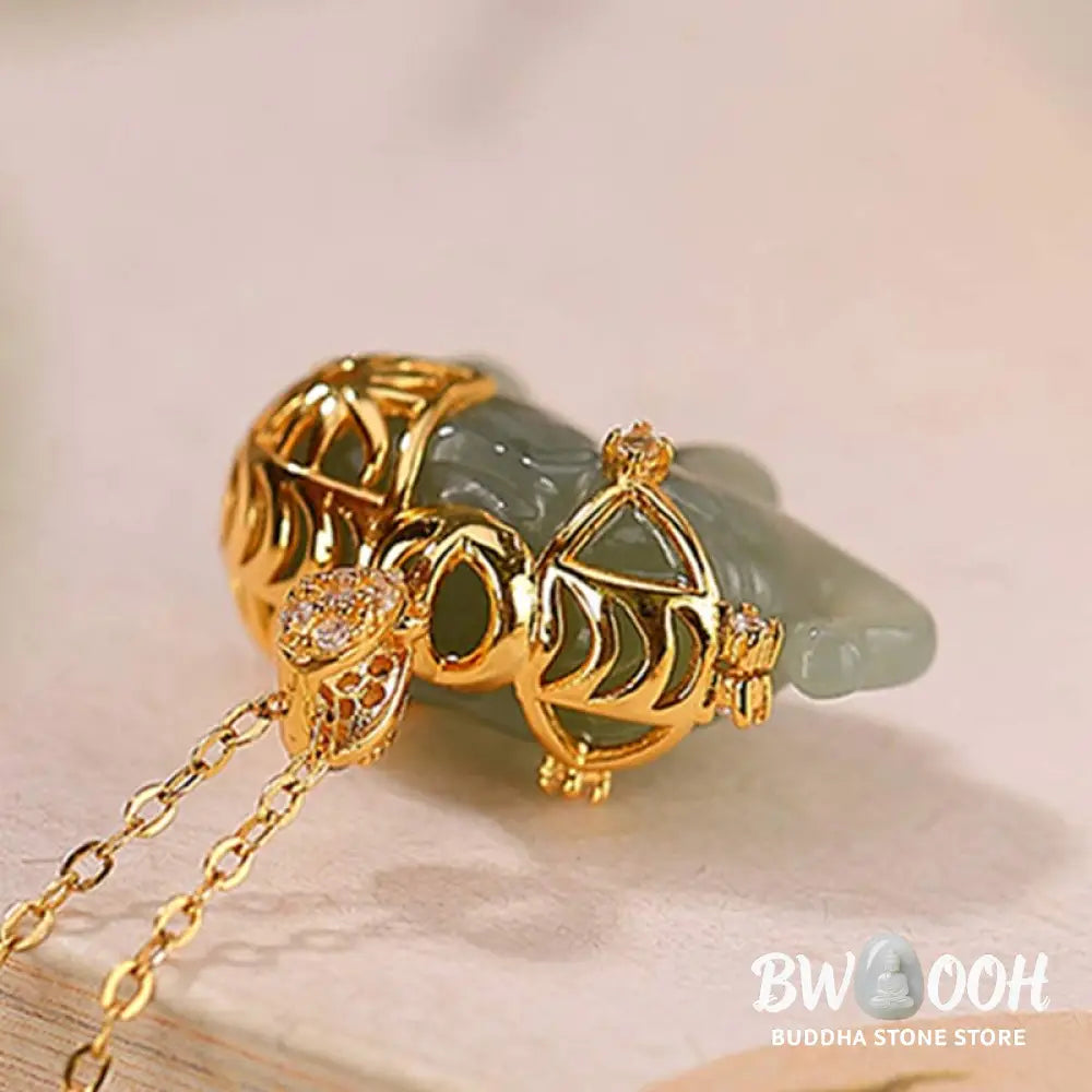 A close-up of the BWOOOH 925 Sterling Silver gold-plated elephant pendant, intricately carved and holding a vibrant jade stone, against a minimalist backdrop, highlighting its 45cm chain. - View 8