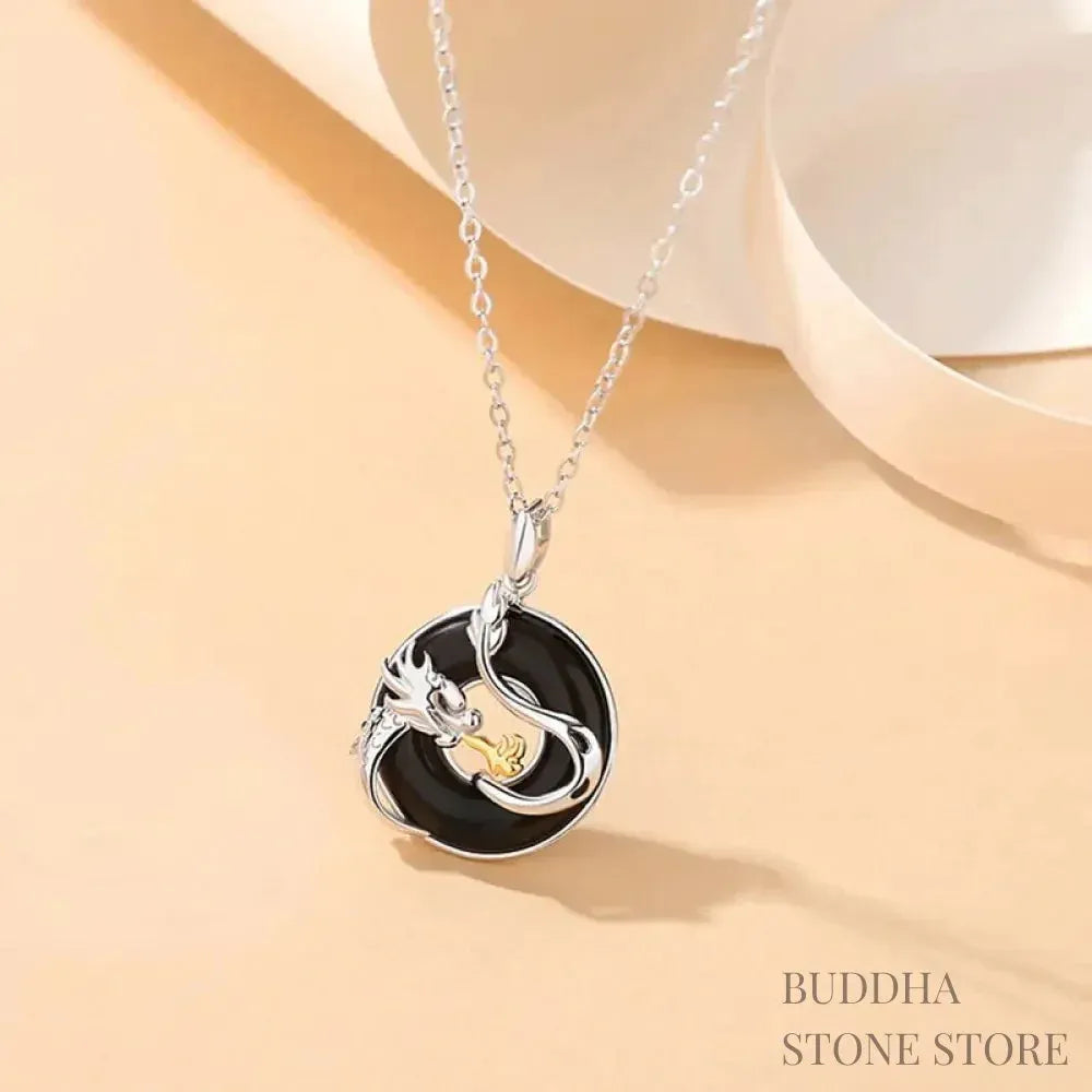 A BWOOOH 925 Sterling Silver Dragon Phoenix Peace Buckle necklace pendant featuring a polished natural Black Onyx and subtle Chalcedony inlay, symbolizing protection, inner peace, and harmonious balance. Ideal for Year of the Dragon alignment. - View 2