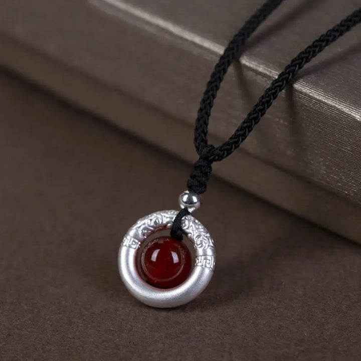 BWOOOH 999 Sterling Silver Red Agate Peace Buckle Blessing Necklace. Handmade woven design, vibrant red agate, auspicious peace buckle for protection and tranquility.