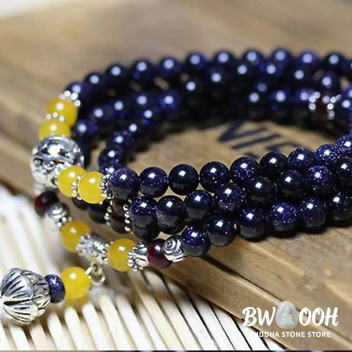BWOOOH Blue Sandstone Wealth Charm Mala. Deep blue 6mm beads with sparkling inclusions, mimicking a starry night. Promotes courage, calm, and wealth for focused meditation. - View 5