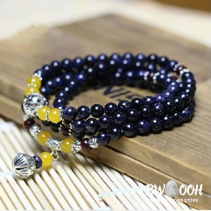 BWOOOH Blue Sandstone Wealth Charm Mala. Deep blue 6mm beads with sparkling inclusions, mimicking a starry night. Promotes courage, calm, and wealth for focused meditation. - View 4