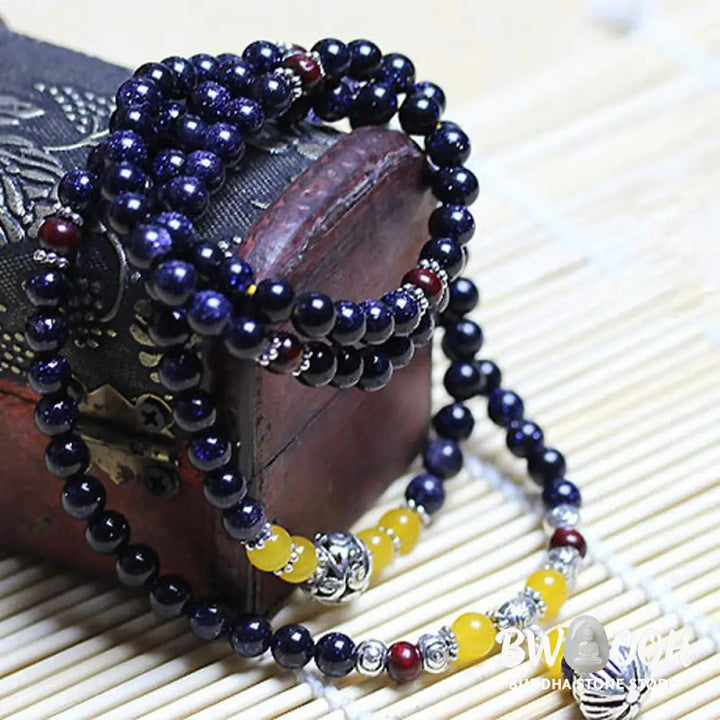 BWOOOH Blue Sandstone Wealth Charm Mala. Deep blue 6mm beads with sparkling inclusions, mimicking a starry night. Promotes courage, calm, and wealth for focused meditation. - View 3