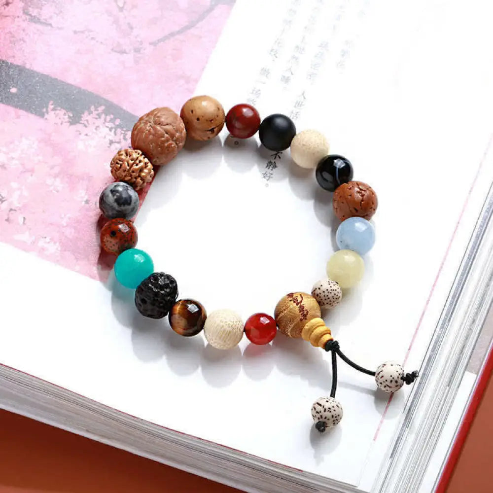 BWOOOH Bodhi Seed Agate Wisdom Harmony Wrist Mala Bracelet featuring dark Bodhi seeds, vibrant red stone, and polished agate beads on a premium elastic string, handmade for meditation and spiritual focus.