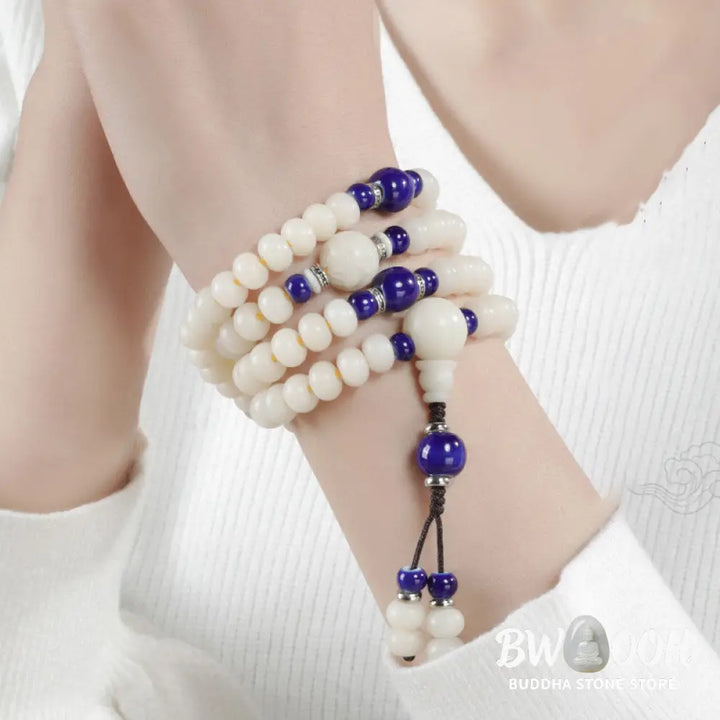 A close-up of the BWOOOH Bodhi Seed Lotus Blessing Charm Bracelet, featuring naturally dark-speckled bodhi seed beads alongside a delicate lotus symbol charm, suitable for unisex wear. - View 6