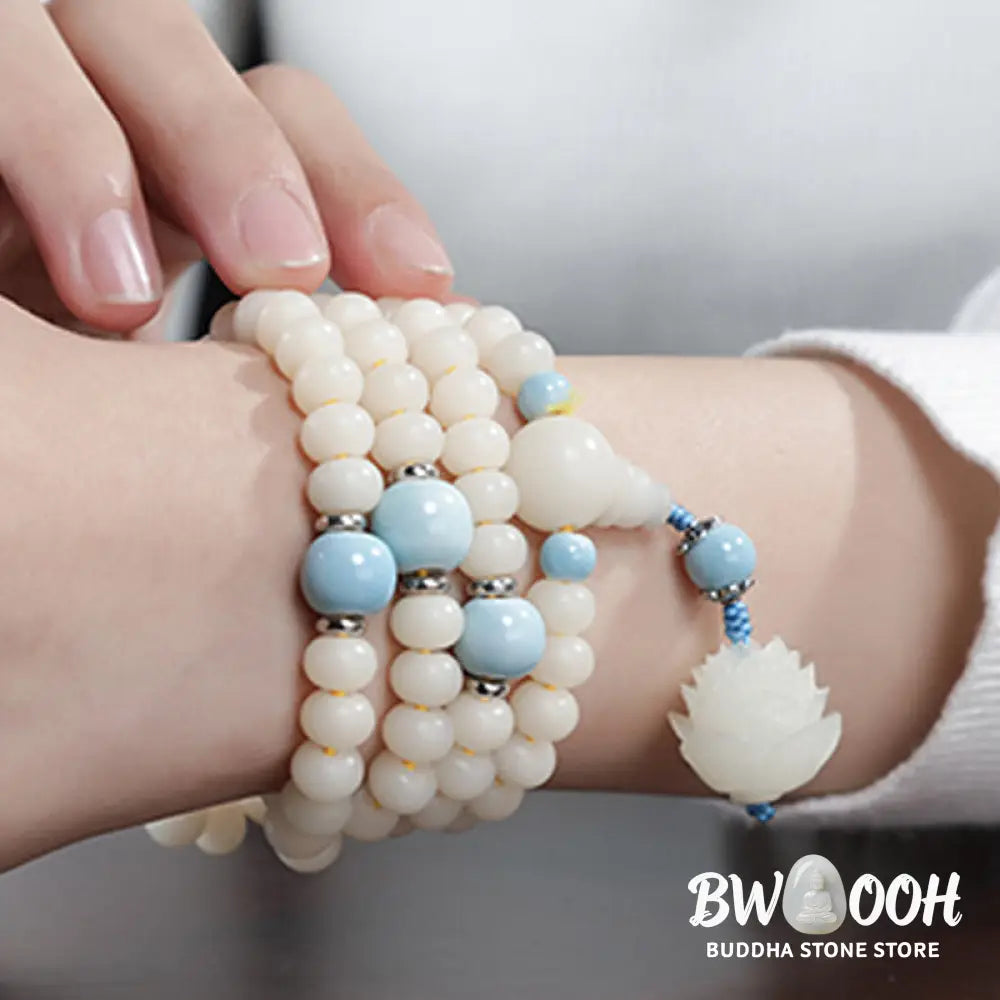 A close-up of the BWOOOH Bodhi Seed Lotus Blessing Charm Bracelet, featuring naturally dark-speckled bodhi seed beads alongside a delicate lotus symbol charm, suitable for unisex wear. - View 12