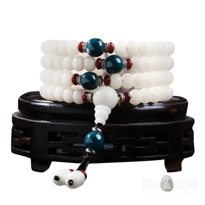 A close-up of the BWOOOH Bodhi Seed Lotus Blessing Charm Bracelet, featuring naturally dark-speckled bodhi seed beads alongside a delicate lotus symbol charm, suitable for unisex wear. - View 4