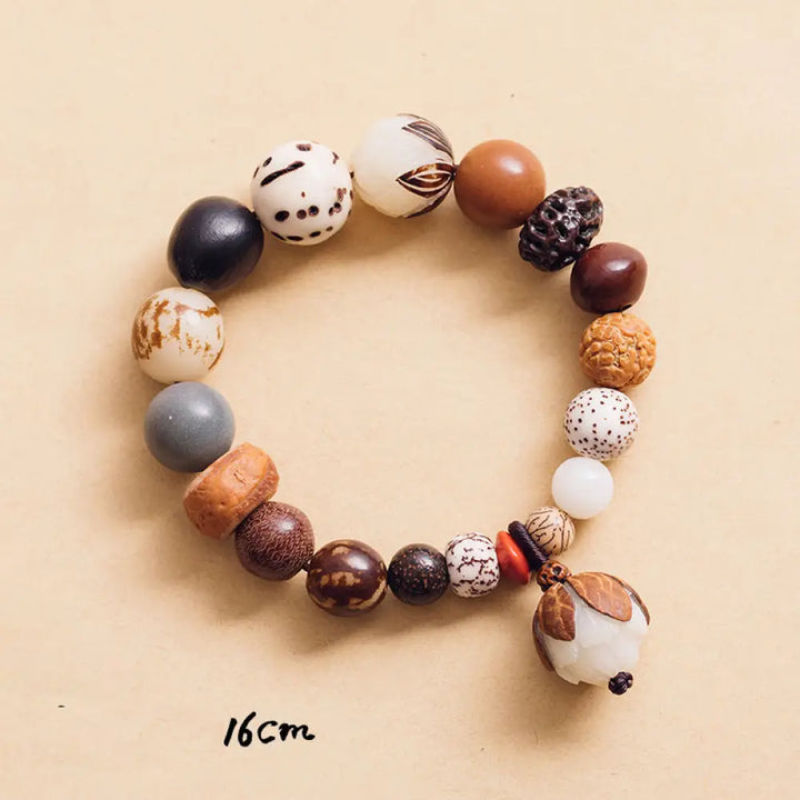 Handcrafted BWOOOH Bodhi Seed Lotus Wisdom Peace Wrist Mala Bracelet, featuring 18 naturally varied bodhi seeds and a delicately engraved lotus symbol, embodying enlightenment, calm, and renewed spiritual focus. - View 8