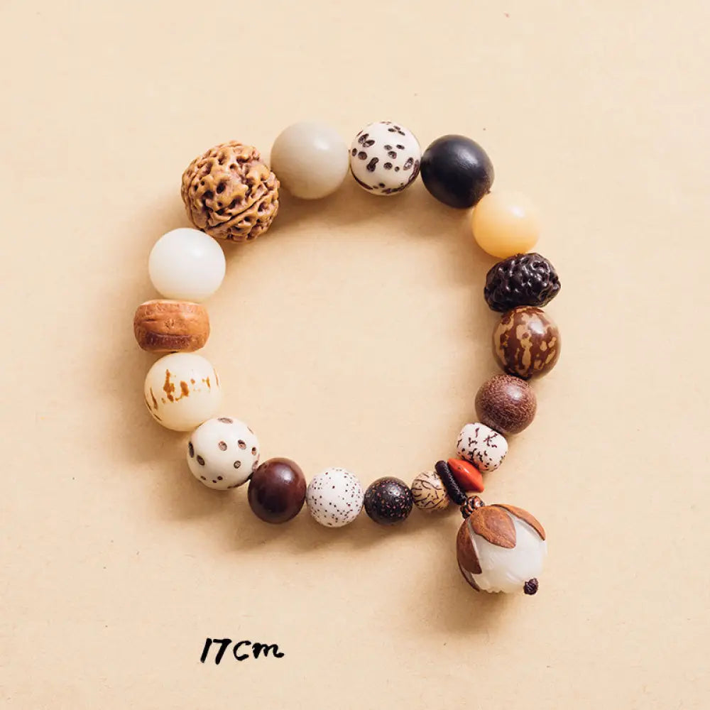 Handcrafted BWOOOH Bodhi Seed Lotus Wisdom Peace Wrist Mala Bracelet, featuring 18 naturally varied bodhi seeds and a delicately engraved lotus symbol, embodying enlightenment, calm, and renewed spiritual focus. - View 10