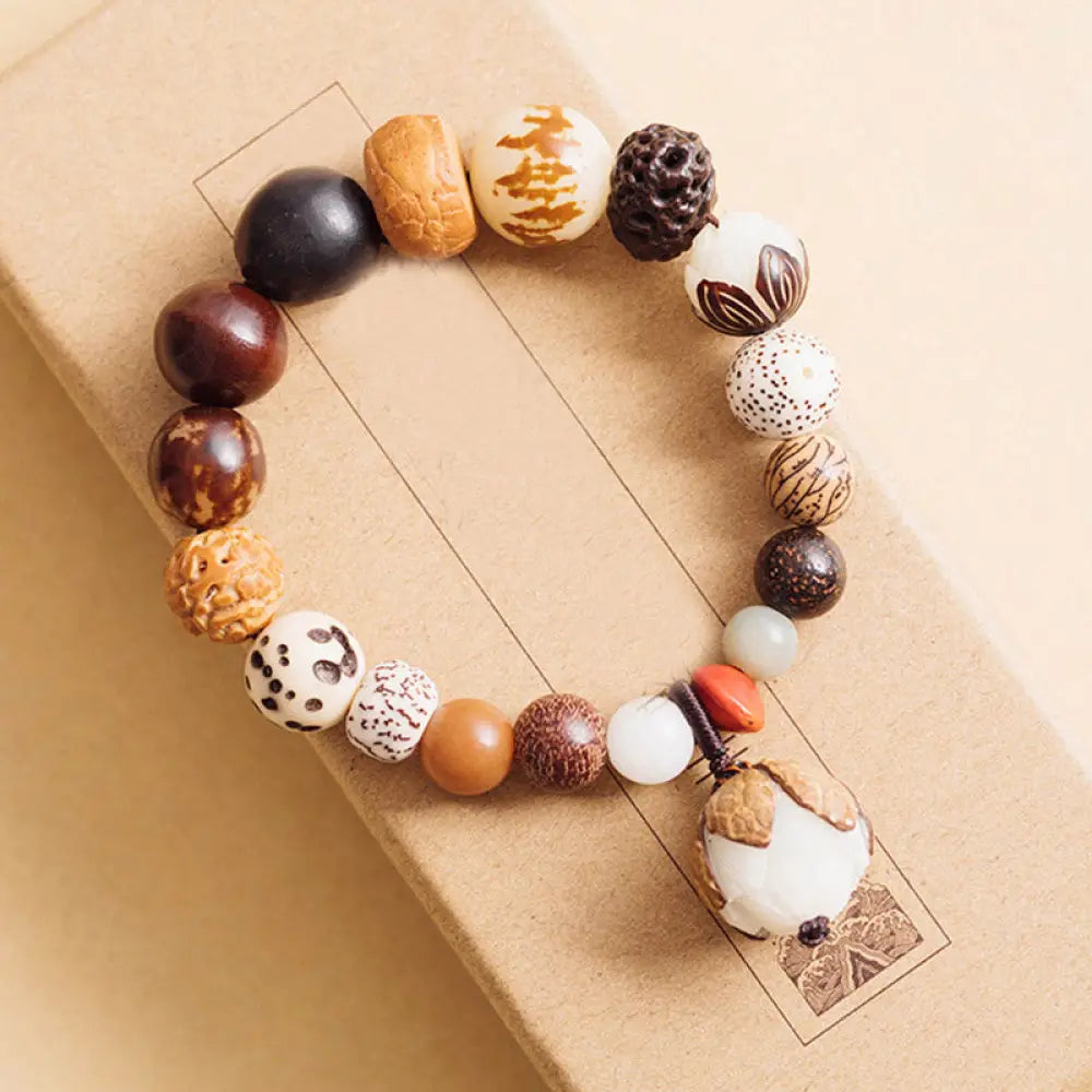 Handcrafted BWOOOH Bodhi Seed Lotus Wisdom Peace Wrist Mala Bracelet, featuring 18 naturally varied bodhi seeds and a delicately engraved lotus symbol, embodying enlightenment, calm, and renewed spiritual focus. - View 12