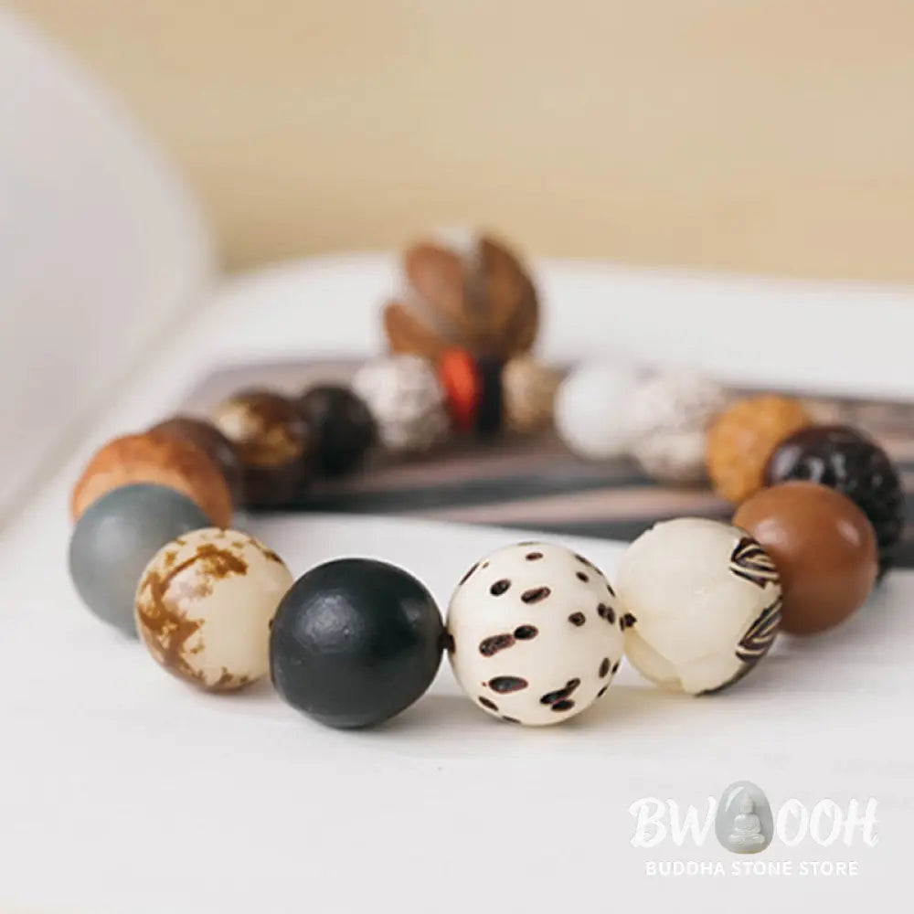 Handcrafted BWOOOH Bodhi Seed Lotus Wisdom Peace Wrist Mala Bracelet, featuring 18 naturally varied bodhi seeds and a delicately engraved lotus symbol, embodying enlightenment, calm, and renewed spiritual focus. - View 14