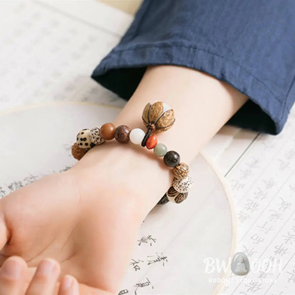 Handcrafted BWOOOH Bodhi Seed Lotus Wisdom Peace Wrist Mala Bracelet, featuring 18 naturally varied bodhi seeds and a delicately engraved lotus symbol, embodying enlightenment, calm, and renewed spiritual focus. - View 3