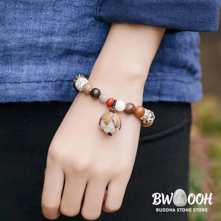 Handcrafted BWOOOH Bodhi Seed Lotus Wisdom Peace Wrist Mala Bracelet, featuring 18 naturally varied bodhi seeds and a delicately engraved lotus symbol, embodying enlightenment, calm, and renewed spiritual focus. - View 4