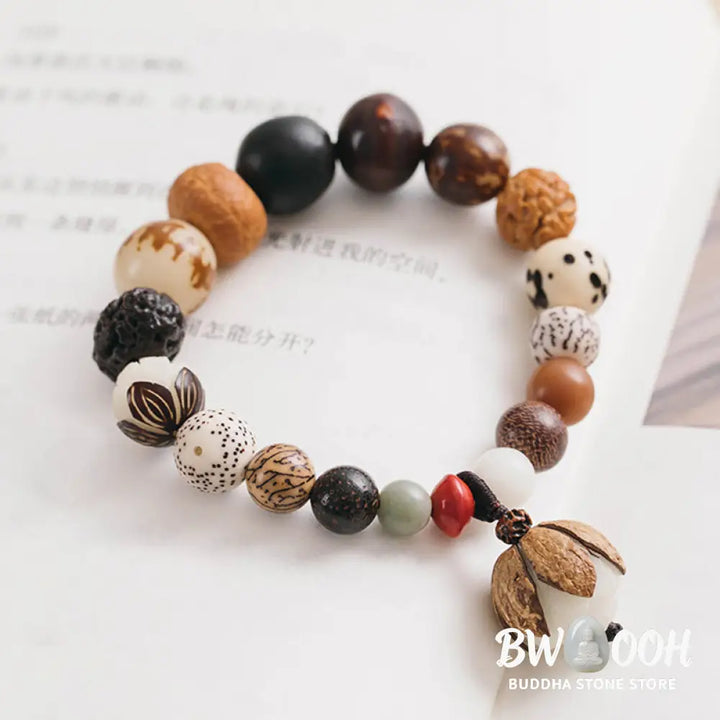 Handcrafted BWOOOH Bodhi Seed Lotus Wisdom Peace Wrist Mala Bracelet, featuring 18 naturally varied bodhi seeds and a delicately engraved lotus symbol, embodying enlightenment, calm, and renewed spiritual focus. - View 11