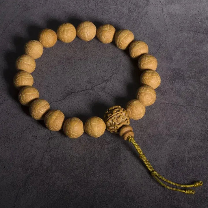 Close-up of BWOOOH Bodhi Seed Wrist Mala featuring dark-speckled 13mm/15mm bodhi seeds on premium elastic string, with a delicate tassel, worn as a meditation accessory or carried as a pocket mala. Unisex.