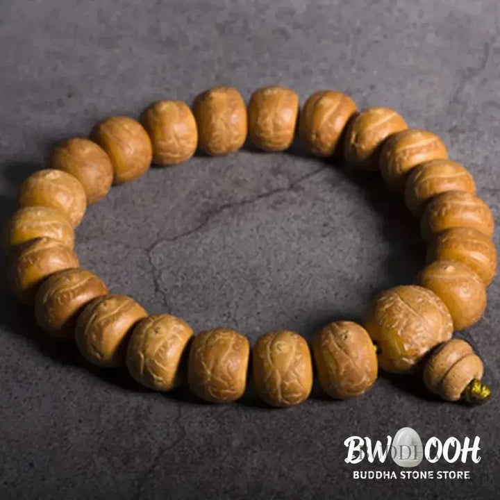 Close-up of BWOOOH Bodhi Seed Wrist Mala featuring dark-speckled 13mm/15mm bodhi seeds on premium elastic string, with a delicate tassel, worn as a meditation accessory or carried as a pocket mala. Unisex. - View 7