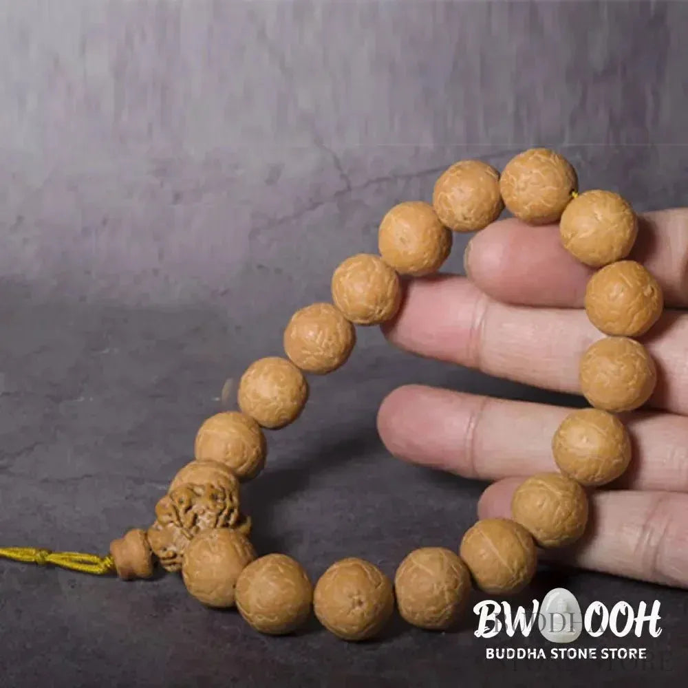 Close-up of BWOOOH Bodhi Seed Wrist Mala featuring dark-speckled 13mm/15mm bodhi seeds on premium elastic string, with a delicate tassel, worn as a meditation accessory or carried as a pocket mala. Unisex. - View 2