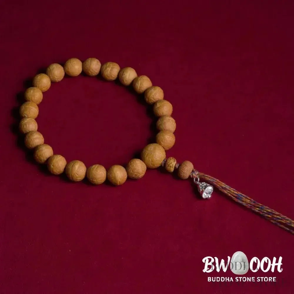 Close-up of BWOOOH Bodhi Seed Wrist Mala featuring dark-speckled 13mm/15mm bodhi seeds on premium elastic string, with a delicate tassel, worn as a meditation accessory or carried as a pocket mala. Unisex. - View 3