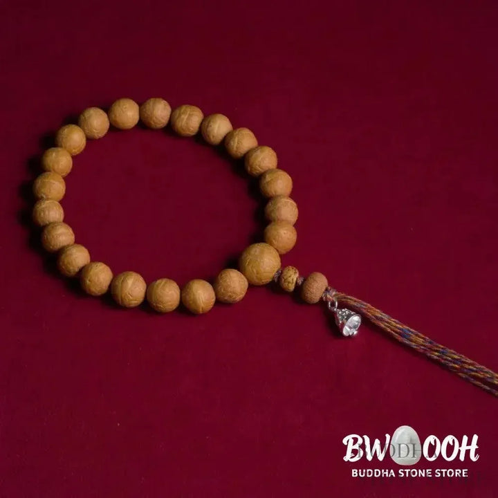 Close-up of BWOOOH Bodhi Seed Wrist Mala featuring dark-speckled 13mm/15mm bodhi seeds on premium elastic string, with a delicate tassel, worn as a meditation accessory or carried as a pocket mala. Unisex. - View 3