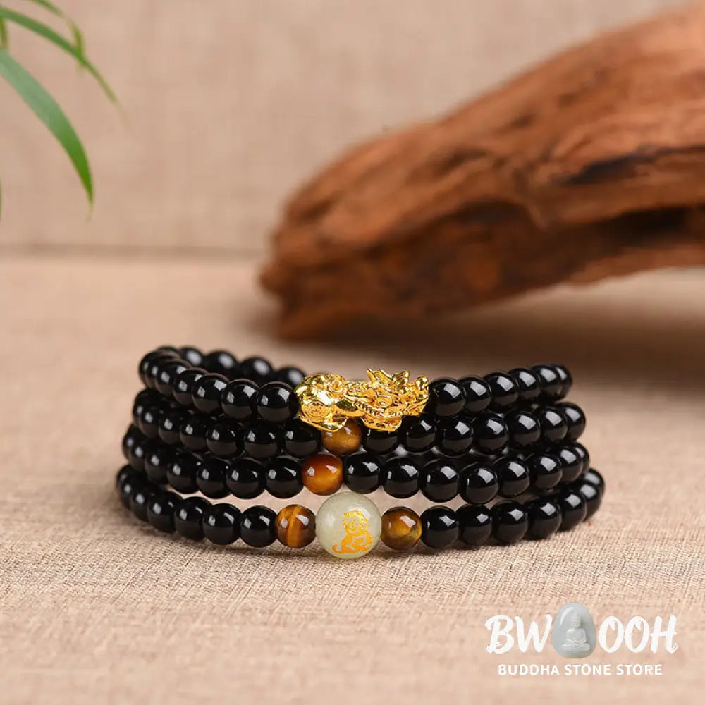 A close-up of the BWOOOH Unisex Chinese Zodiac Obsidian PiXiu Protection Mala Bracelet featuring polished black 6mm or 8mm obsidian beads and a detailed PiXiu charm, designed for spiritual grounding and attracting prosperity. - View 2