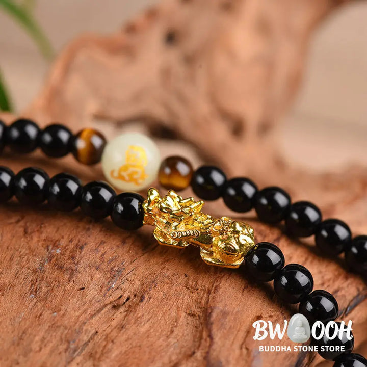 A close-up of the BWOOOH Unisex Chinese Zodiac Obsidian PiXiu Protection Mala Bracelet featuring polished black 6mm or 8mm obsidian beads and a detailed PiXiu charm, designed for spiritual grounding and attracting prosperity. - View 4