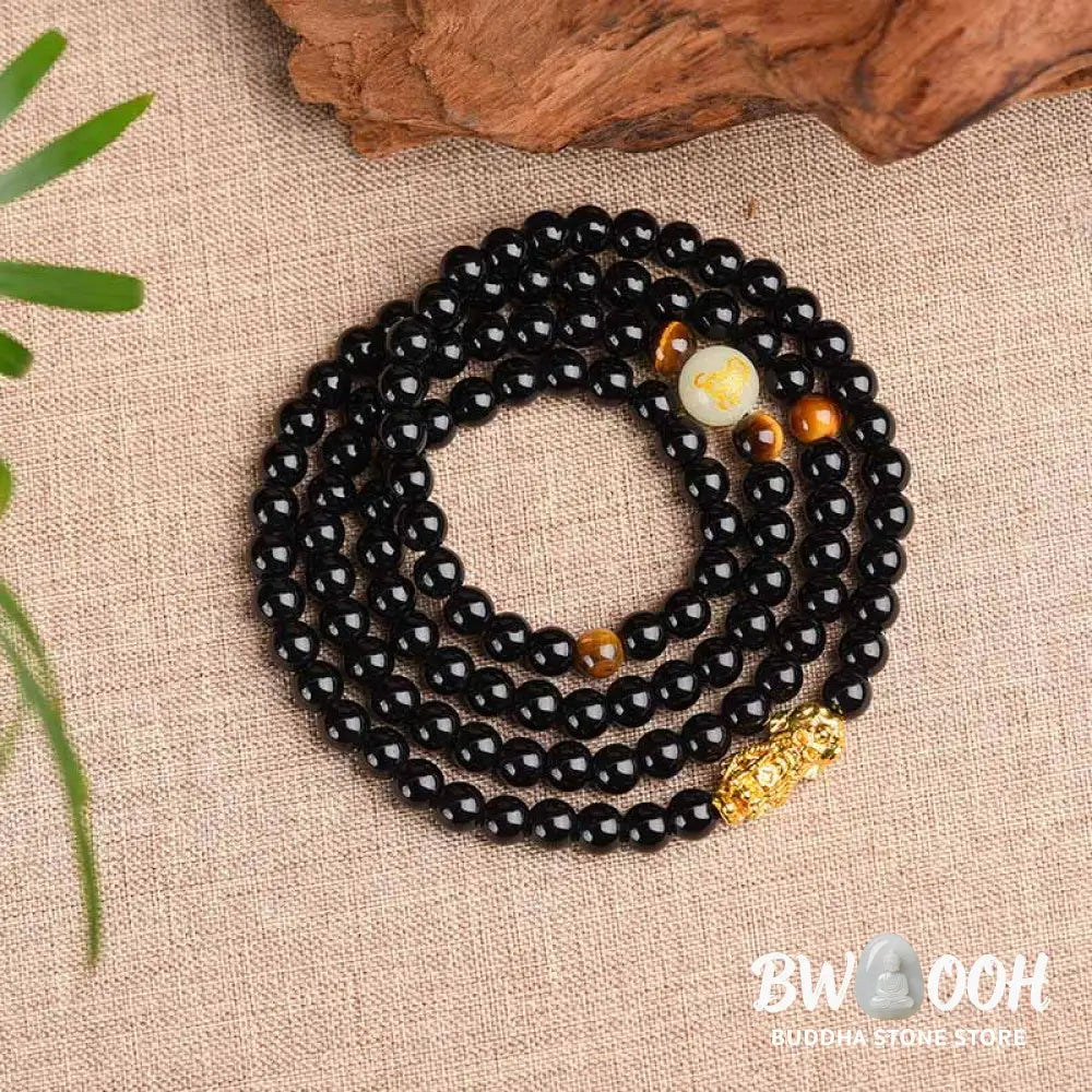 A close-up of the BWOOOH Unisex Chinese Zodiac Obsidian PiXiu Protection Mala Bracelet featuring polished black 6mm or 8mm obsidian beads and a detailed PiXiu charm, designed for spiritual grounding and attracting prosperity. - View 3