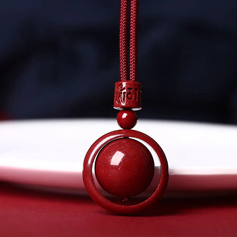 BWOOOH Cinnabar Om Mani Padme Hum PiXiu Blessing Necklace. Detailed 14mm cinnabar bead with etched mantra and PiXiu talisman, 50cm cord, for spiritual protection and prosperity.